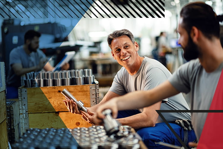 Man smiling and looking at his co-worker whilst working on steel products. Overlayed with Make UK branding
